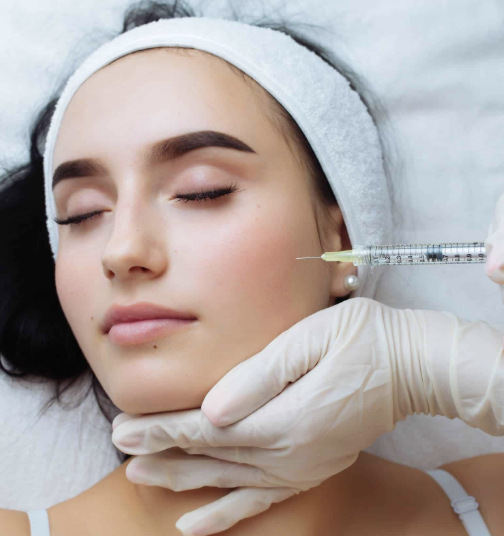 Professional cosmetic facial injection in a clinical setting, representing collagen stimulators